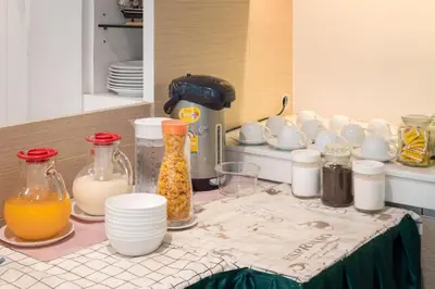 a table with bottles of milk and other items on it at Samyan Serene Hotel in Bangkok