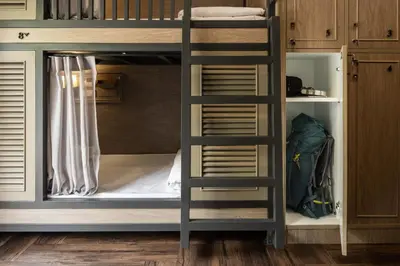 a bunk bed with a ladder in a room at Warm Window Silom in Bangkok