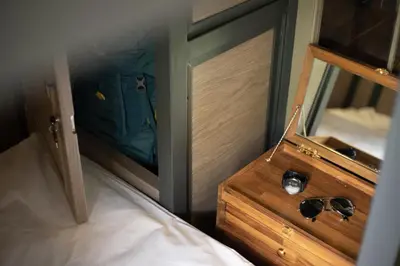 a view of a bedroom with a mirror and a bed at Warm Window Silom in Bangkok