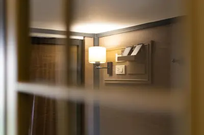a room with a door with a lamp on it at Warm Window Silom in Bangkok