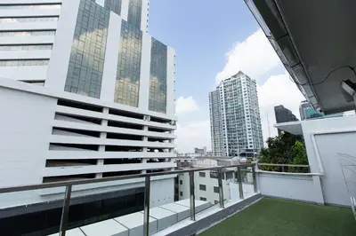 a balcony with a view of a city at Simply Sleep Hostel in Bangkok