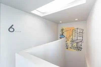 a room with a drawing on the wall at Simply Sleep Hostel in Bangkok