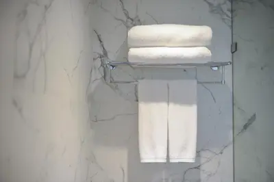 a towel rack in a bathroom with towels at Syama Nana in Bangkok