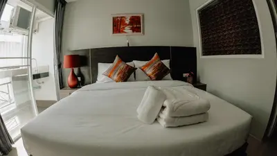 a bedroom with a bed with white towels on it at Step One at Bangkok in Bangkok