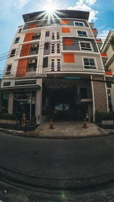 a tall building with the sun shining on it at Step One at Bangkok in Bangkok