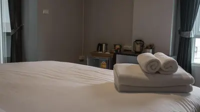 a hotel room with two towels on a bed at Step One at Bangkok in Bangkok