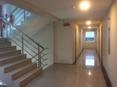 a hallway with a staircase in a house at Step One at Bangkok in Bangkok