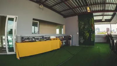 a yellow table in a room with a large window at Step One at Bangkok in Bangkok