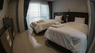 a hotel room with two beds and a window at Step One at Bangkok in Bangkok