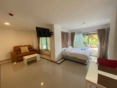 a bedroom with a bed and a chair and a couch at The Lux Ladprao 10 in Bangkok