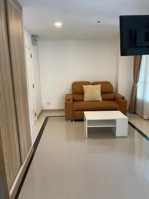a living room with a couch and a coffee table at The Lux Ladprao 10 in Bangkok
