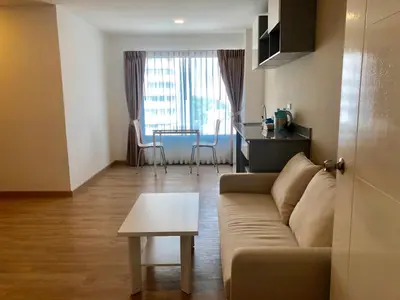 a living room with a couch and a table at The Lux Ladprao 10 in Bangkok