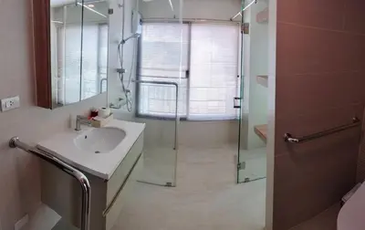 a bathroom with a sink and a glass shower at The Lux Ladprao 10 in Bangkok