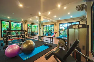 a gym with a bunch of weights and exercise equipment at Penyos Residence in Bangkok