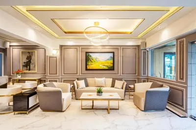 a living room with furniture and a coffered ceiling at Penyos Residence in Bangkok