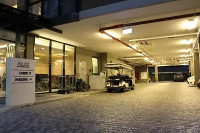an empty parking garage with a golf cart in it at Alix Bangkok Hotel in Bangkok