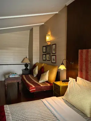 a hotel room with a couch and a bed at Arun Residence in Bangkok