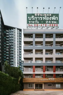 a large building with a sign on top of it at Season Place in Bangkok