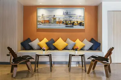 a living room with a couch and two chairs at Season Place in Bangkok