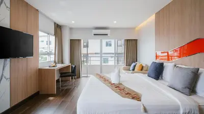 a hotel room with a large bed and a desk at Season Place in Bangkok