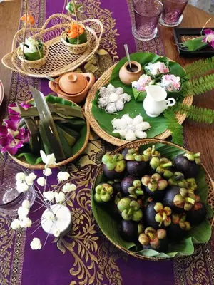 a table with green plates of food on it at SSIP Boutique Dhevej Bangkok in Bangkok