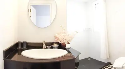 a bathroom with a sink and a mirror on a counter at SSIP Boutique Dhevej Bangkok in Bangkok