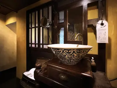 a bathroom with a sink on top of a dresser at Old Capital Bike Inn - SHA Certified in Bangkok