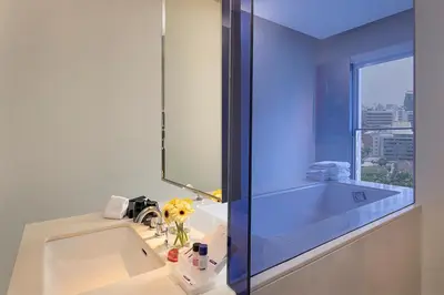 a bathroom with a sink and a mirror at Mode Sathorn Hotel in Bangkok