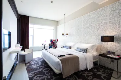a bedroom with a large bed and a large window at Mode Sathorn Hotel in Bangkok