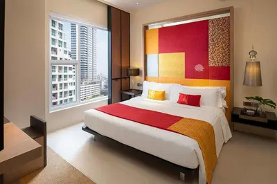 a bedroom with a large bed and a large window at Mode Sathorn Hotel in Bangkok