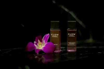 a group of three beauty products and a purple flower at GLOW Sukhumvit 5 in Bangkok
