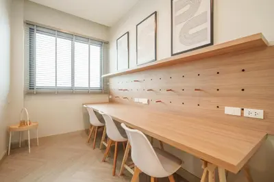 a dining room with a long table and chairs at Triple Four in Bangkok