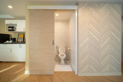 a bathroom with a toilet in a room at Triple Four in Bangkok