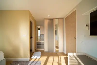 a hallway of a house with a glass door at Triple Four in Bangkok