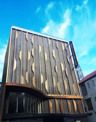 a building with a facade with wooden panels on it at The Key Premier Hotel Sukhumvit Bangkok in Bangkok
