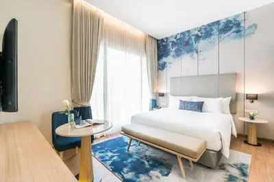a hotel room with a bed and a table at The Key Premier Hotel Sukhumvit Bangkok in Bangkok