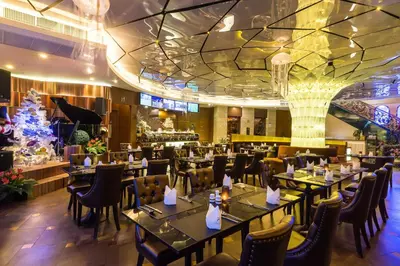 a restaurant with tables and chairs and a christmas tree at Amaranta Hotel in Bangkok
