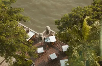 an aerial view of a house with trees and water at The Peninsula Bangkok in Bangkok