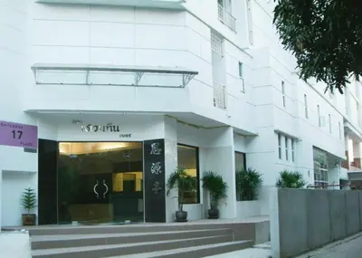 a store front of a white building at Ratchada 17 Place in Bangkok
