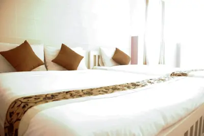 a large white bed with a leopard pattern on it at Ratchada 17 Place in Bangkok