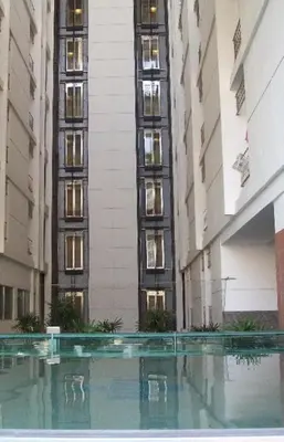 a view of a building with a pool in front of it at Ratchada 17 Place in Bangkok