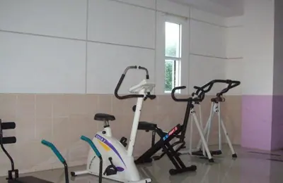 a gym with two exercise bikes in a room at Ratchada 17 Place in Bangkok