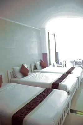 a row of beds lined up in a room at Ratchada 17 Place in Bangkok