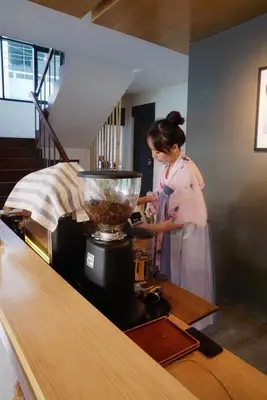 a woman standing in a kitchen with a blender at YOLO Bangkok Boutique Hotel in Bangkok