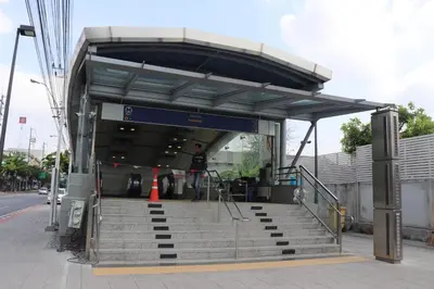 a bus stop with stairs and a person standing at it at Kasayapi Hotel in Bangkok