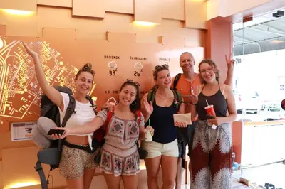 a group of people posing for a picture in a room at The LOL Elephant Hostel in Bangkok