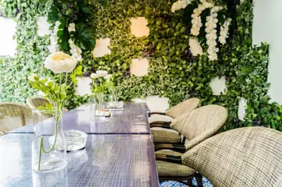 a table with a vase with a flower on it at The LOL Elephant Hostel in Bangkok