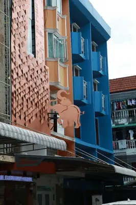 a building with a painting on the side of it at The LOL Elephant Hostel in Bangkok
