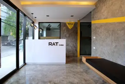 an entrance to a building with a sign on the wall at Ratch66 Huai Khwang MRT in Bangkok