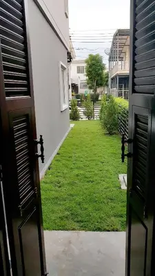 a view of a yard from the door of a house at NIDO Guest House in Ban Bang Phang